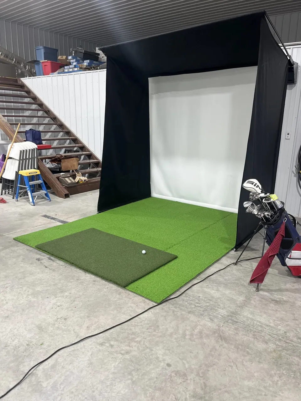 A Duffer Golf simulator installed in a real garage